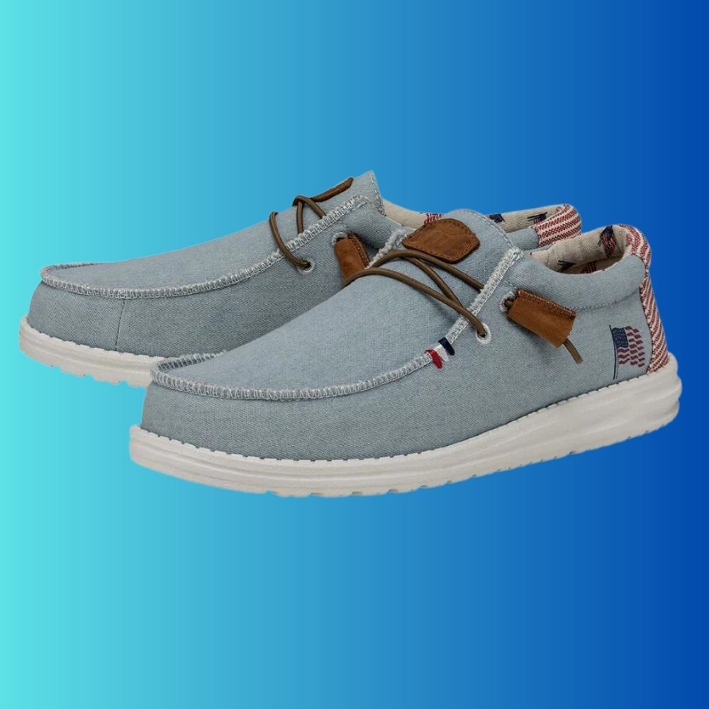 Pair of Denim (light blue) Hey Dude Wally American shoes for men.  American Flag on side and white and red stripes on the heel.