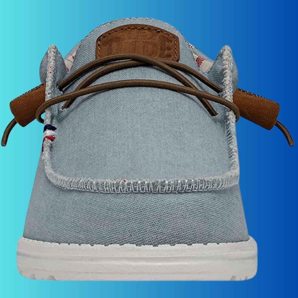 Front view of Hey Dude Wally Americana Shoe.  Denim Stripe (light blue) with brown laces ind Hey Dude Log on the tongue.